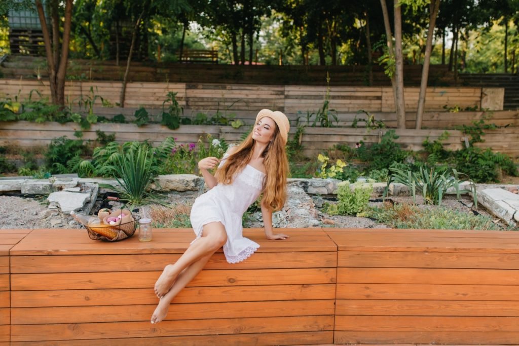 A woman in a dress sitting on a complex multi-level decking.