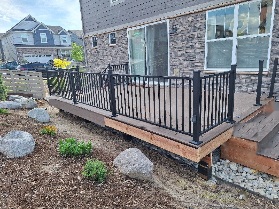 Deckorators deck builder in Highlands Ranch: new Deckorators composite deck with black aluminum railing built by Elevate in Sterling Ranch