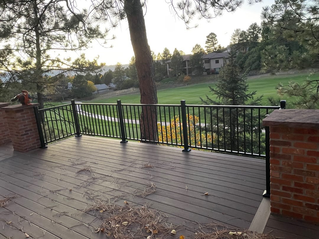 Composite deck with black aluminum railing and a wide Colorado view, built by Elevate Landscape & Spas