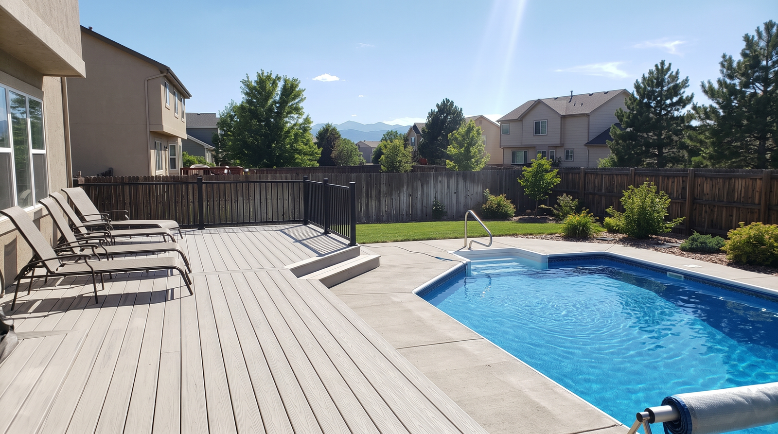 Composite deck beside a backyard pool in Colorado