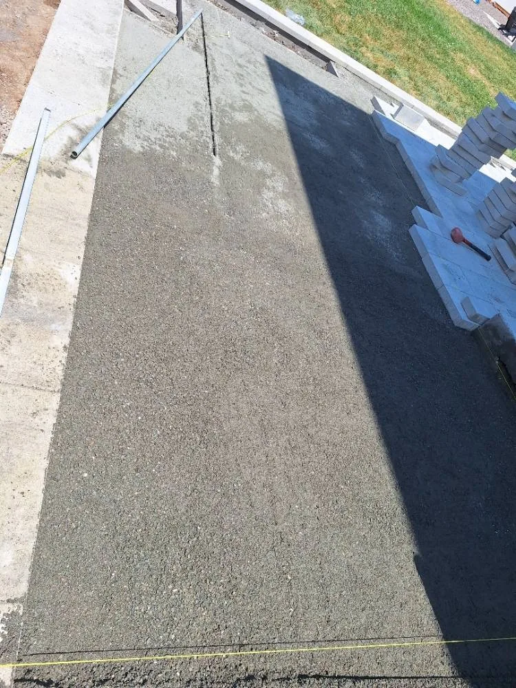 Compacted, screeded base leveled with screed rails before pavers are laid