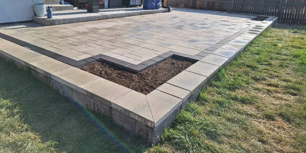 Finished paver patio with a dark picture-frame border, built by Elevate, a paver patio contractor in Highlands Ranch