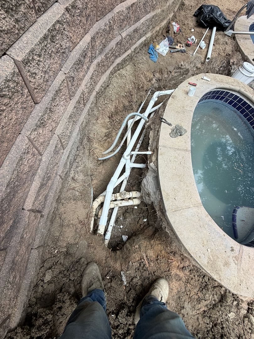 Pool deck repair: pool plumbing lines exposed under the deck to fix a leak